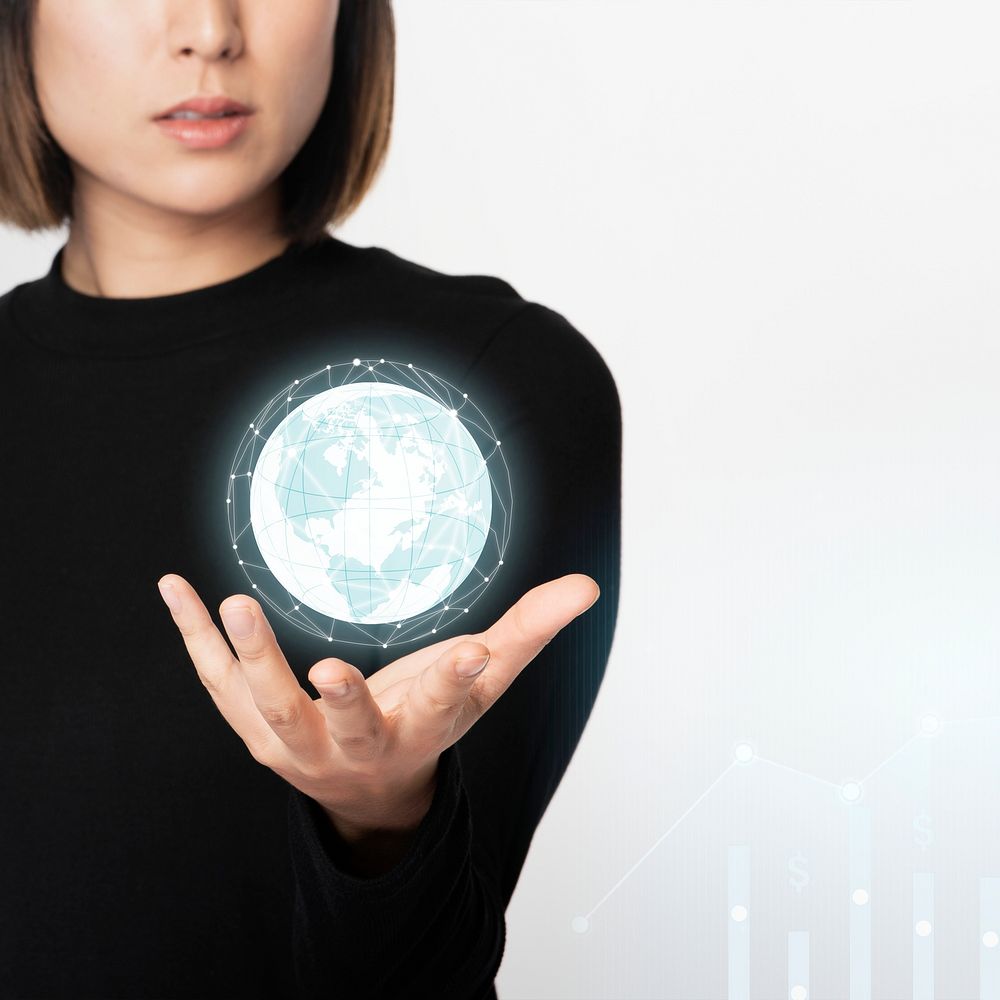 Businesswoman holding a digitally generated globe 