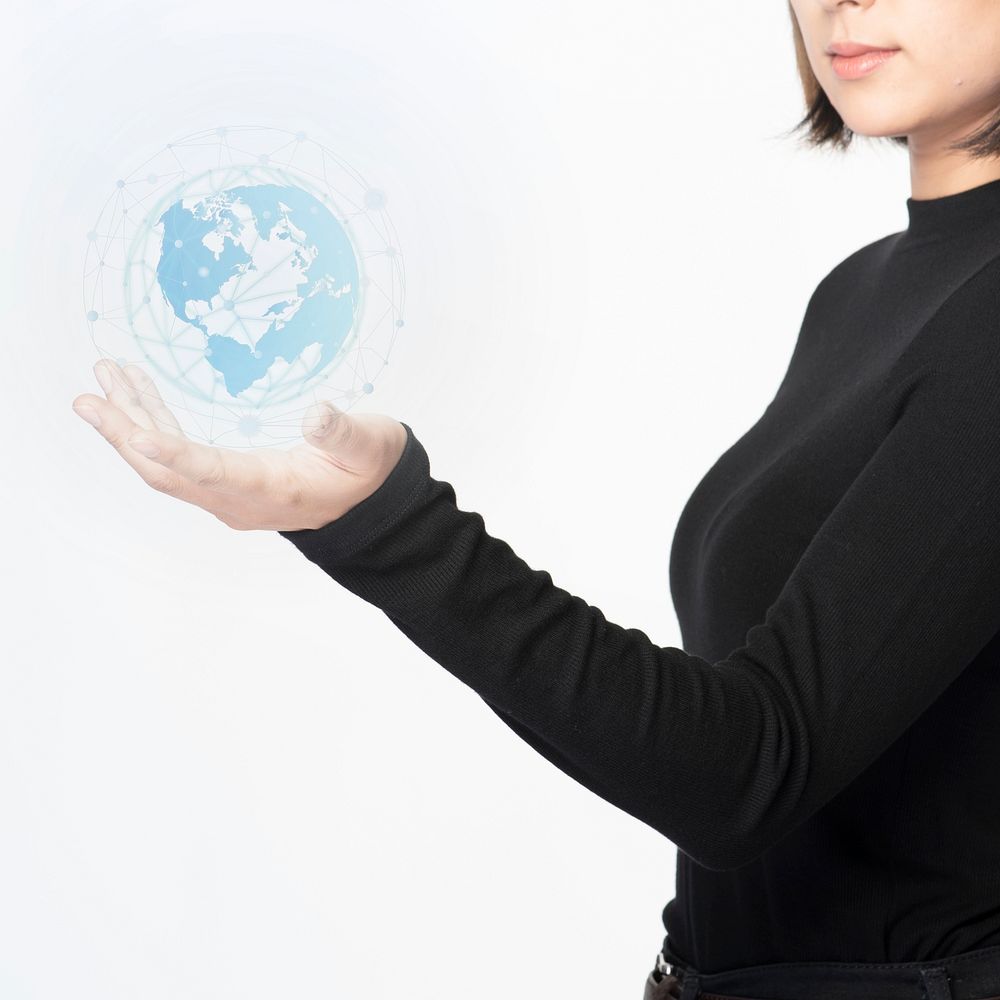 Businesswoman holding a digitally generated globe