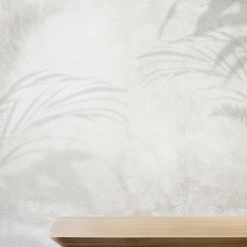 Product backdrop, empty wooden table with concrete wall and plant shadow