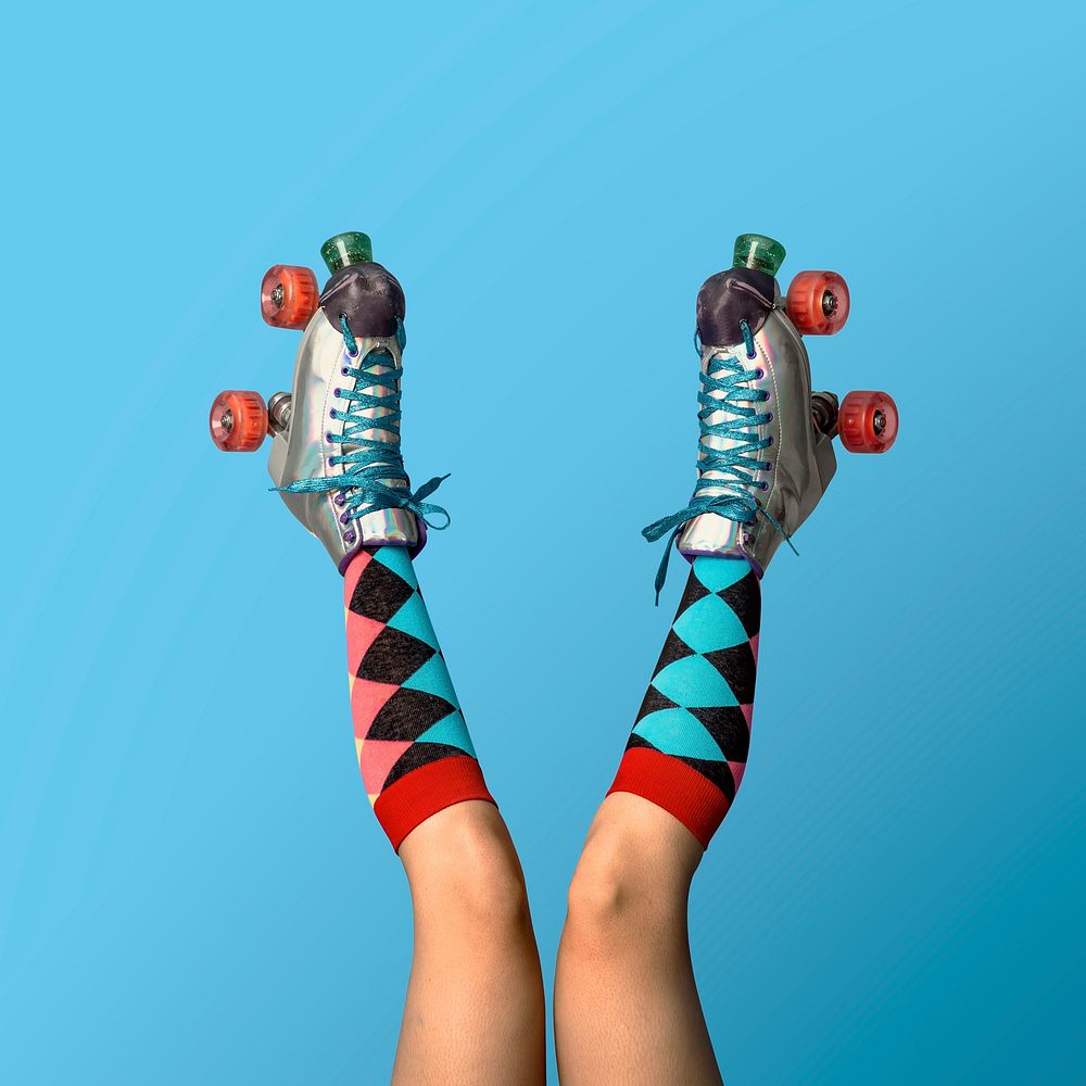 Legs in  roller skate shoes against a blue background 