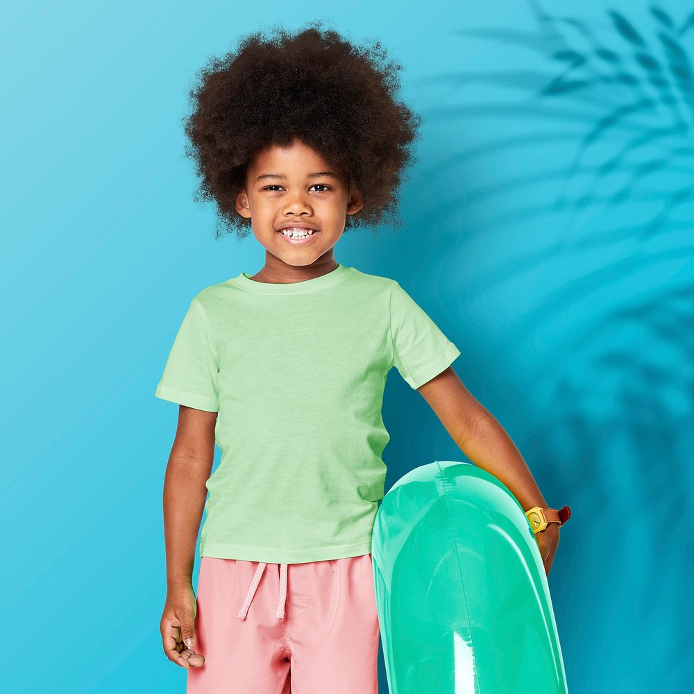 Black boy with swim ring in studio