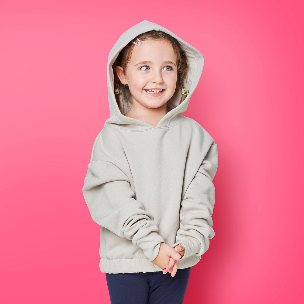 Little cute girl in a beige hoodie