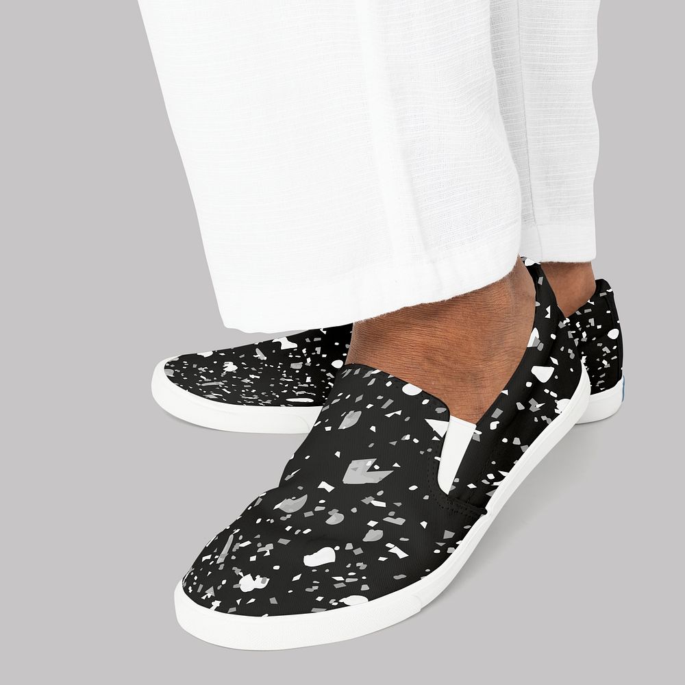 Black slip-on shoes with abstract design casual apparel close up with design space