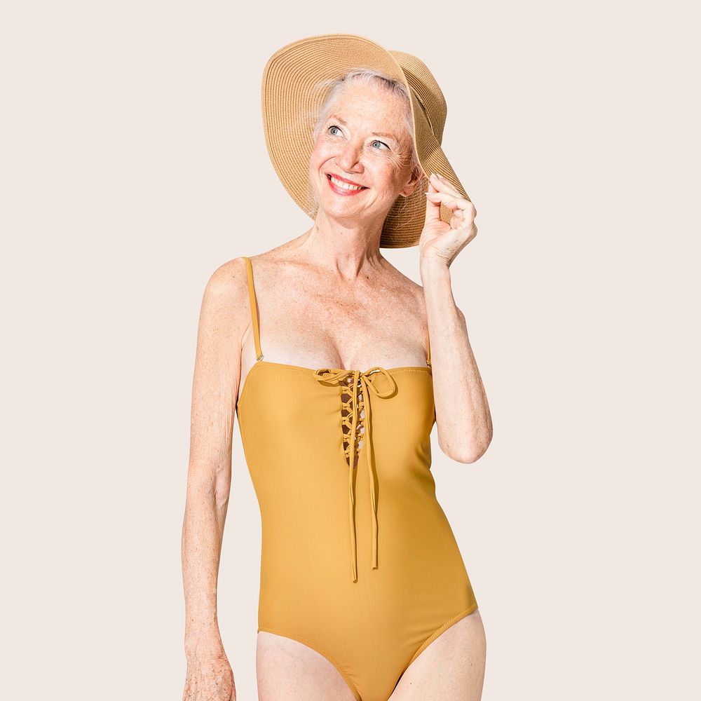 Senior woman in yellow swimsuit and sun hat summer fashion