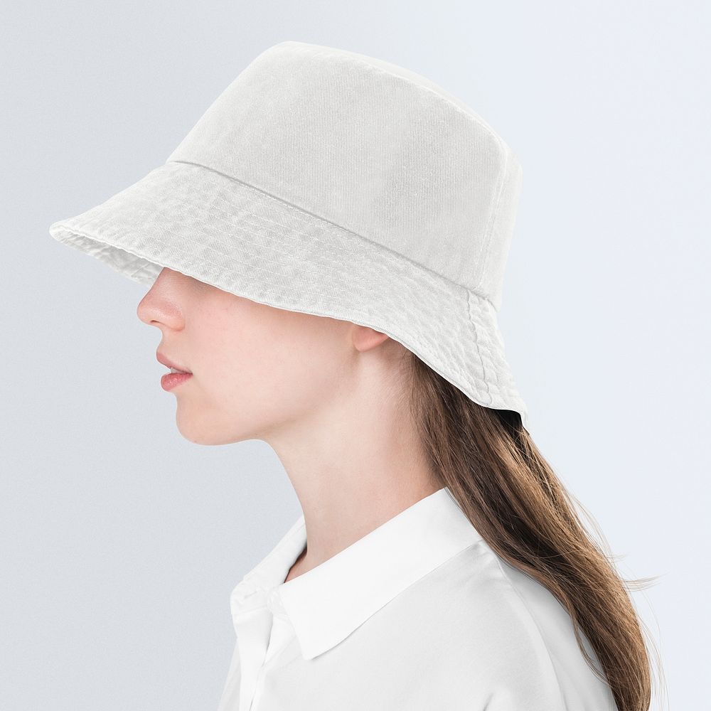 Teenage girl in beige bucket hat for street fashion shoot