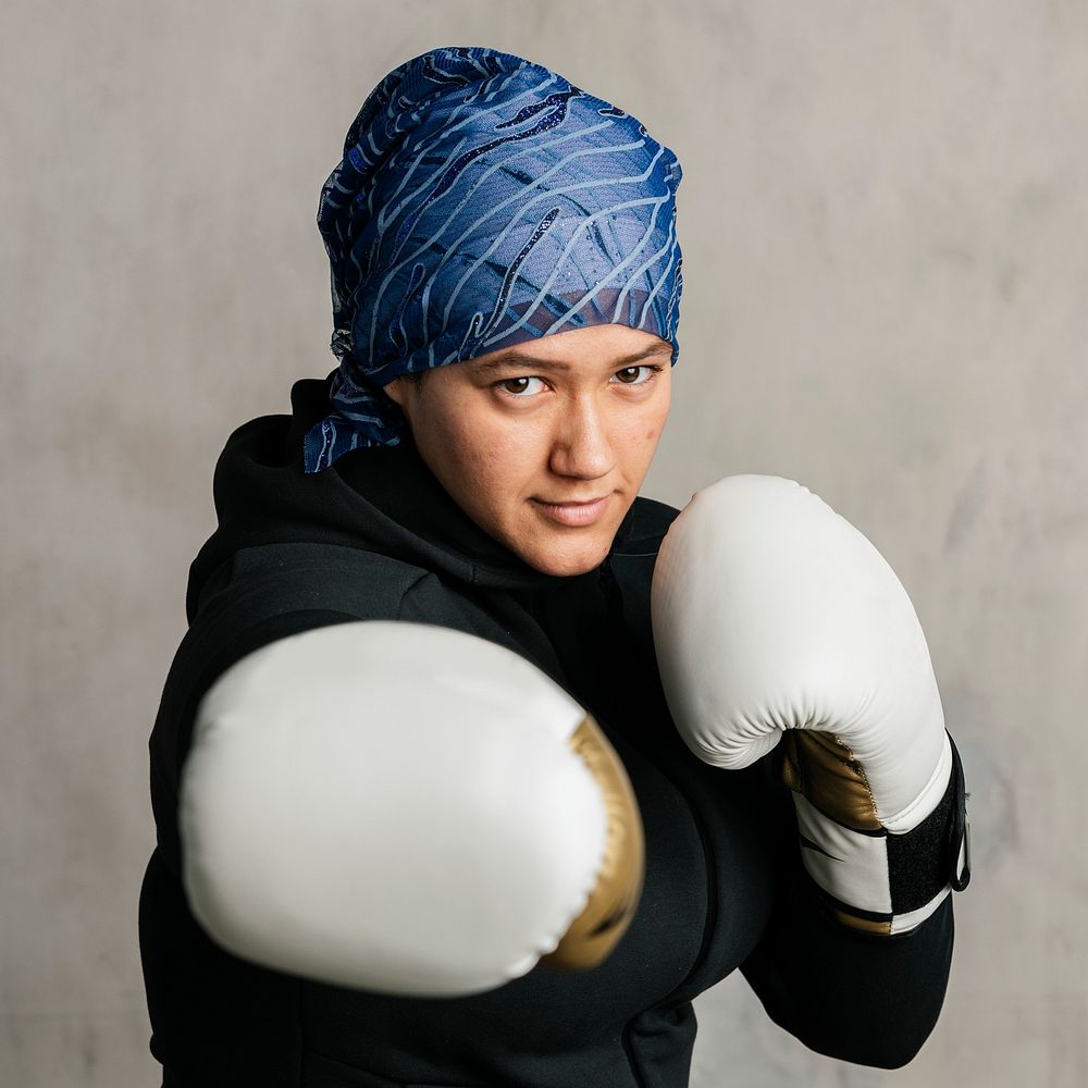 Young Islamic woman wearing a bandana while boxing
