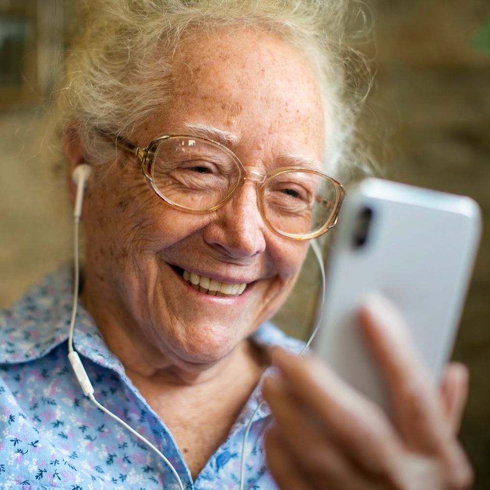 Senior woman smiling in video call in the new normal