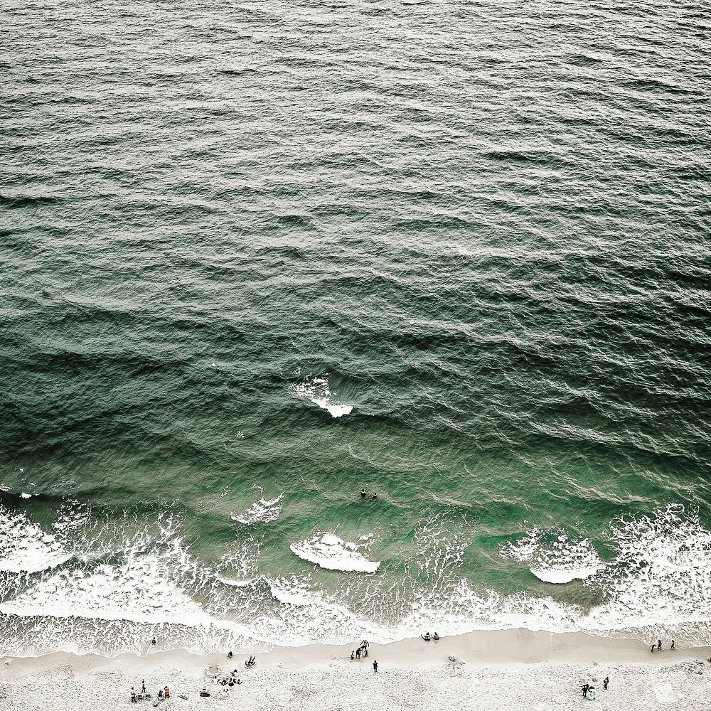 Drone aerial view of the ocean waves washing on the sand Gulf Shores. Original public domain image from Wikimedia Commons