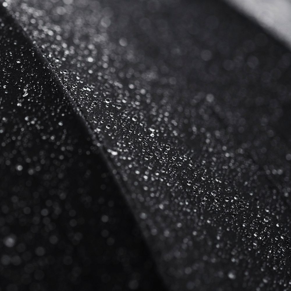 Macro shot of tiny droplets of water on a black surface. Original public domain image from Wikimedia Commons