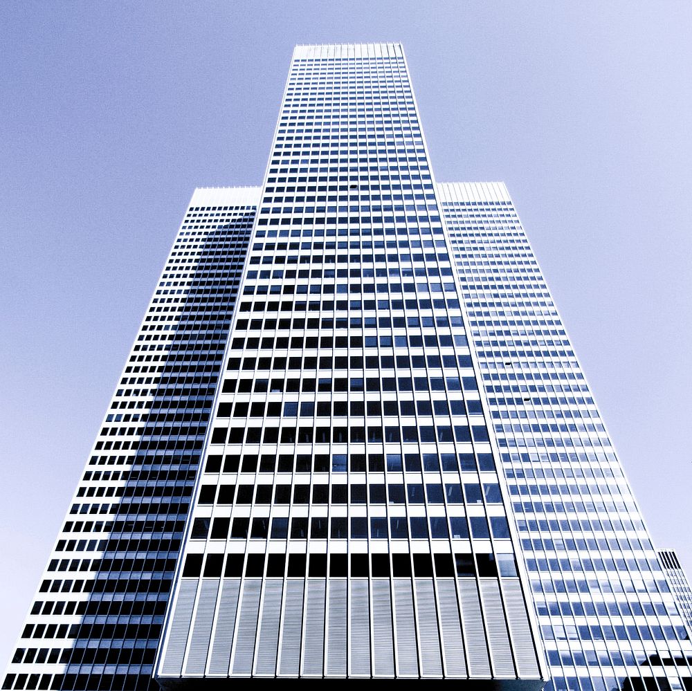 A tall white skyscraper on a bright day in Montreal. Original public domain image from Wikimedia Commons