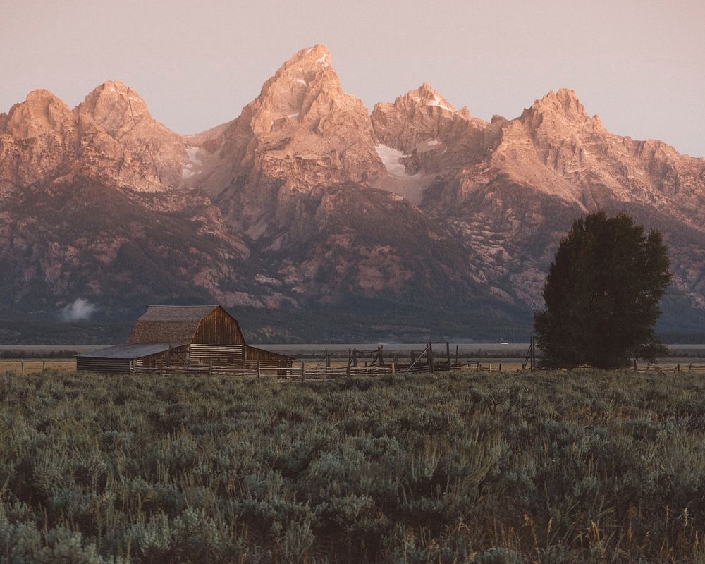 Barn at the foot of craggy mountains in the Grand Teton National Park. Original public domain image from Wikimedia Commons