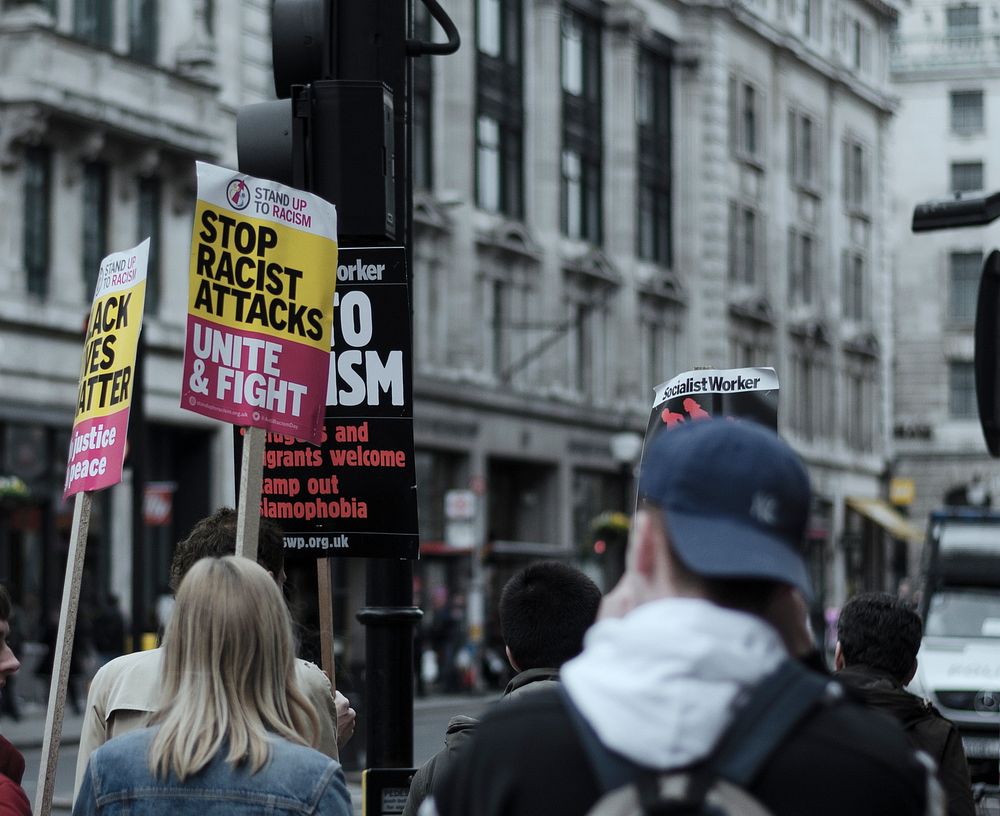 People with protest signs in Oxford Street, London. Original public domain image from Wikimedia Commons