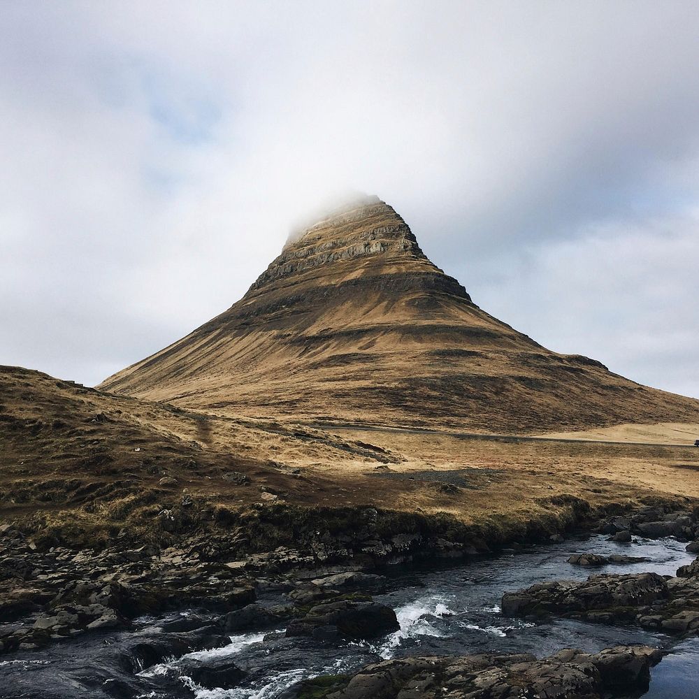 Mountain in Kirkjufell disappears into the cloudy sky. Original public domain image from Wikimedia Commons