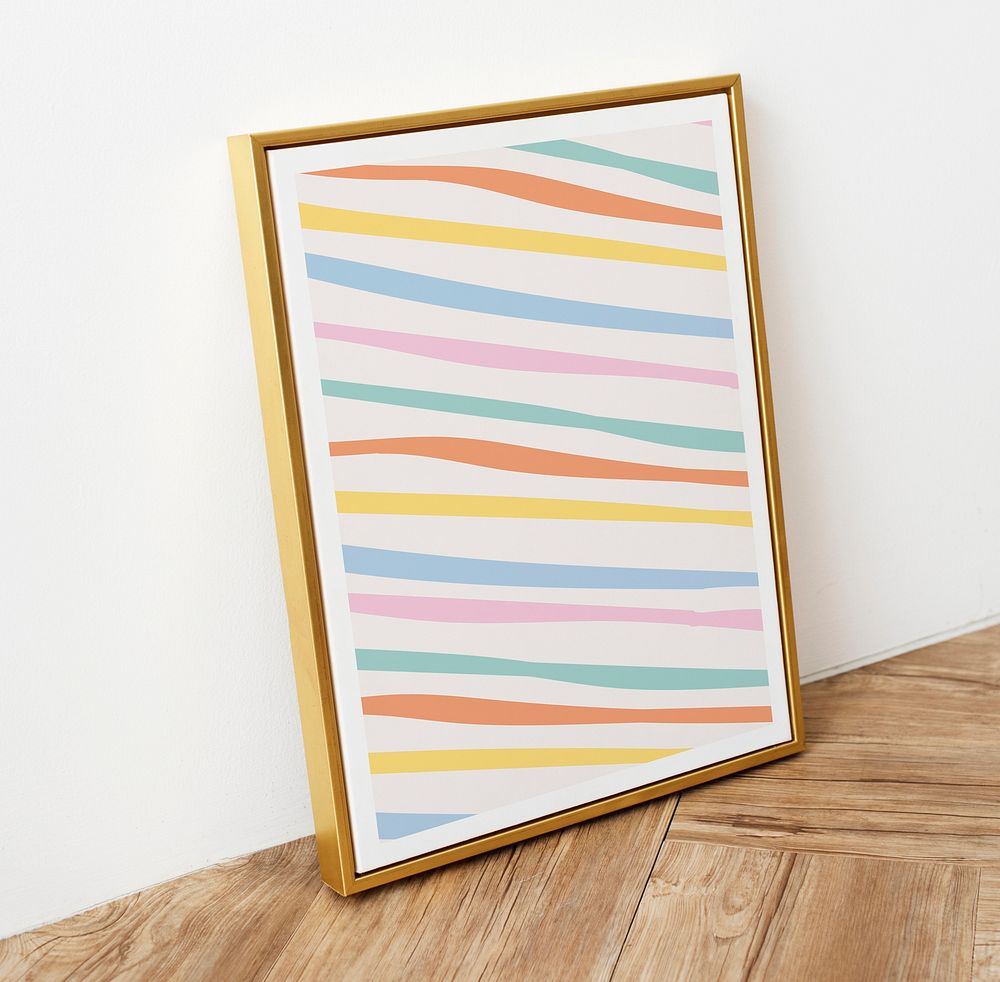 Cute pastel stripes pattern in a picture frame on wooden floor