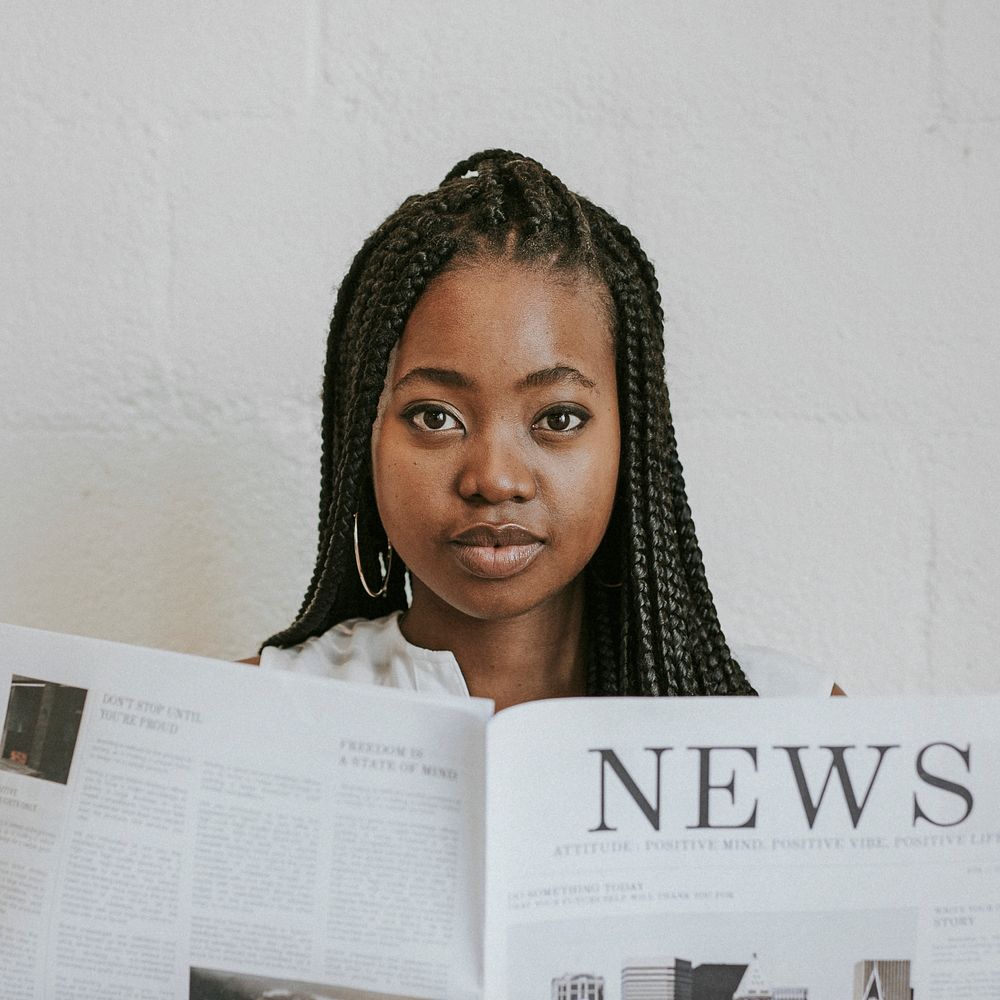 Black woman reading a newspaper