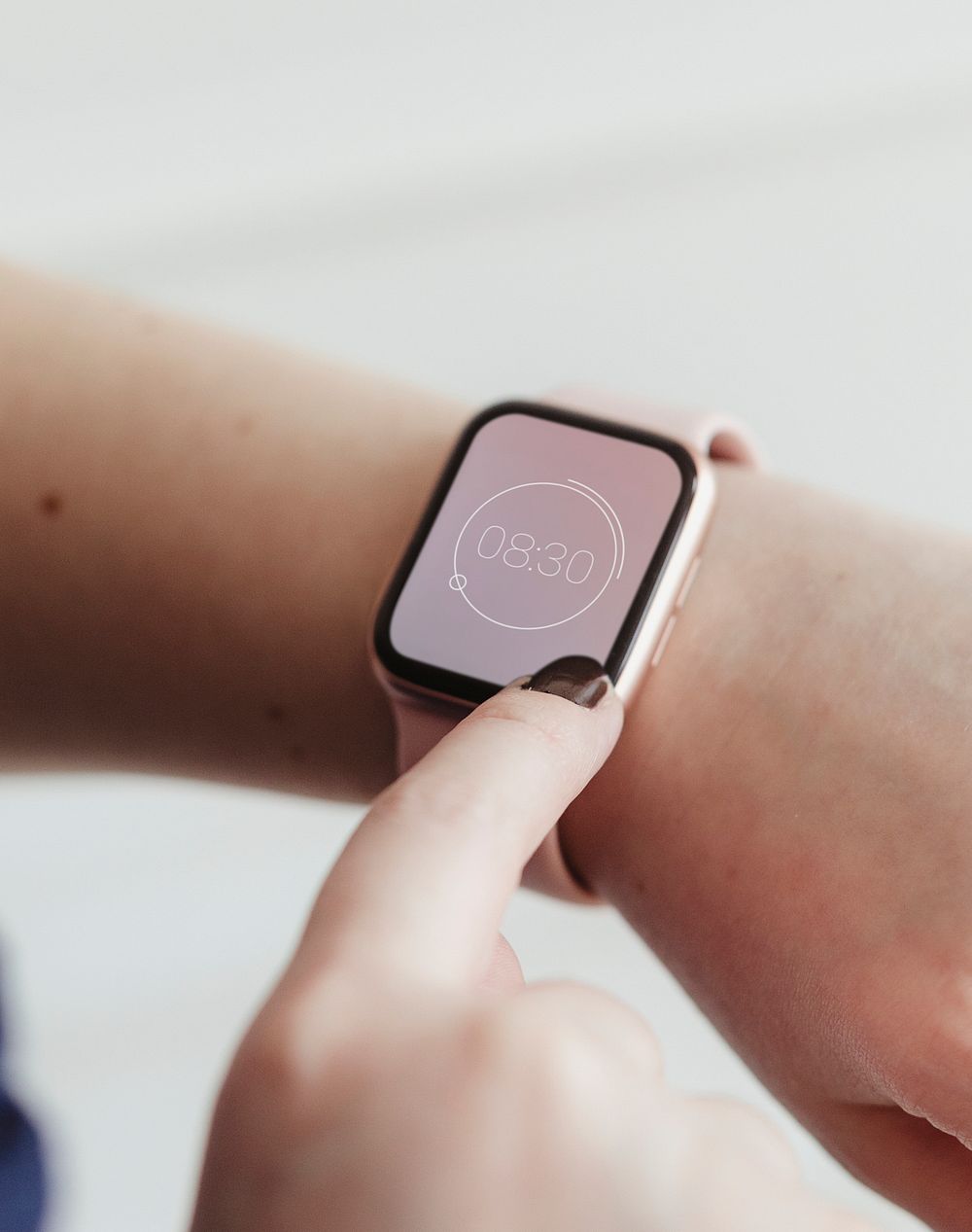 Woman looking at the time on her digital smartwatch