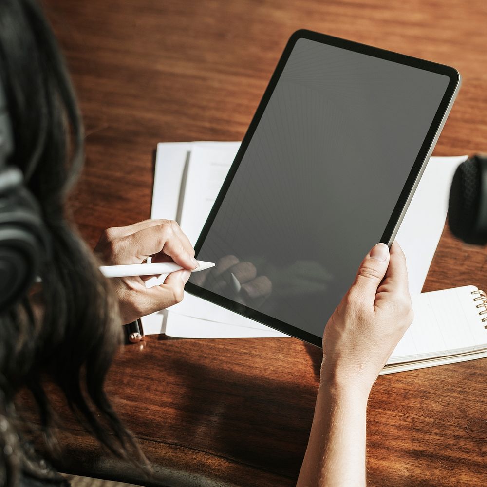 Woman writing on a digital tablet mobile phone wallpaper