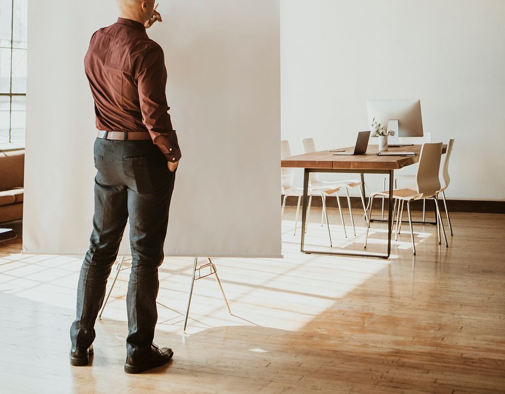 Businessman standing by a presentation board