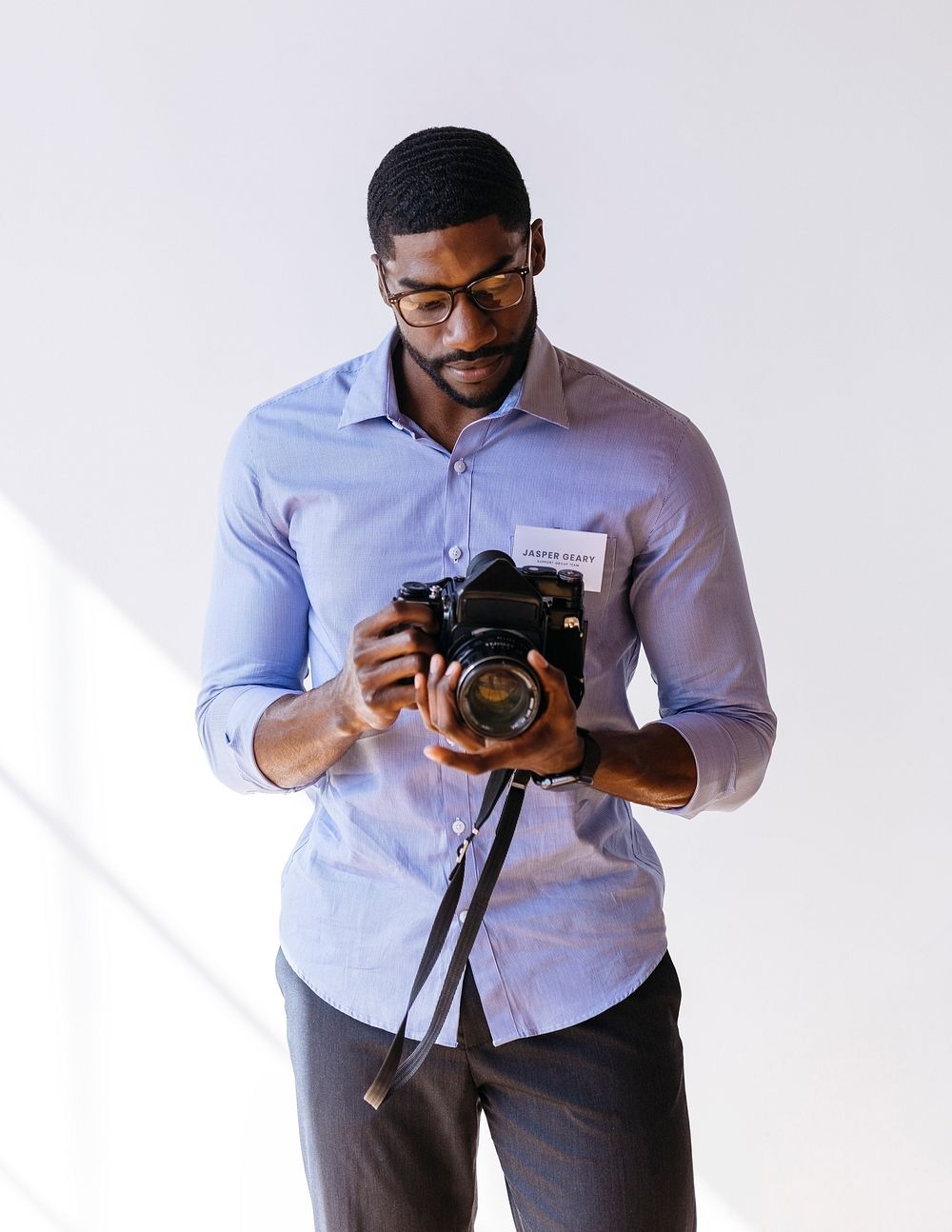 Black photographer using a retro film camera