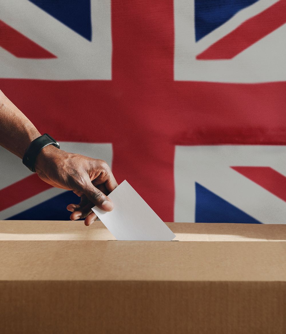 British man casting his vote to a ballot box