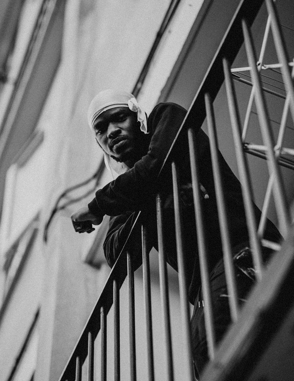 Man looking down from his balcony during social isolation due to the covid-19 pandemic in Britain.