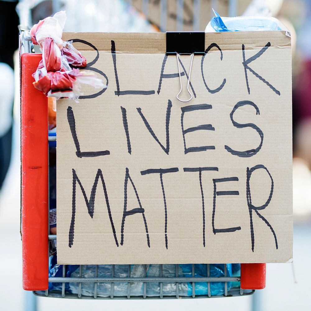 Black lives matter on a cardboard clipped on a shopping cart