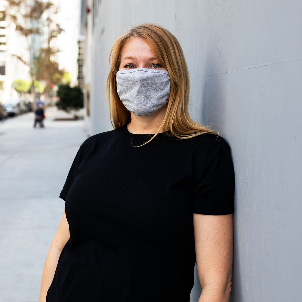 Blonde woman wearing mask in the city outdoor photoshoot