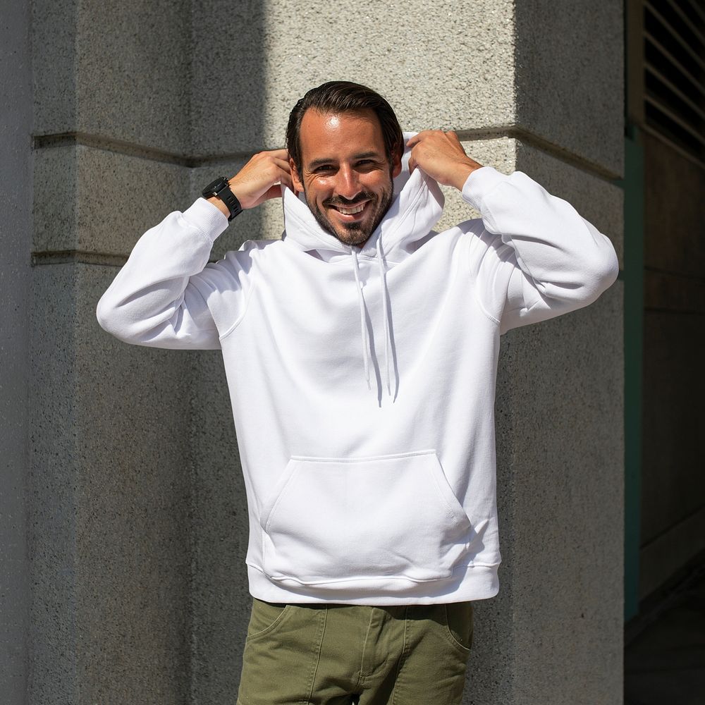 White hoodie on man with green pants in the city
