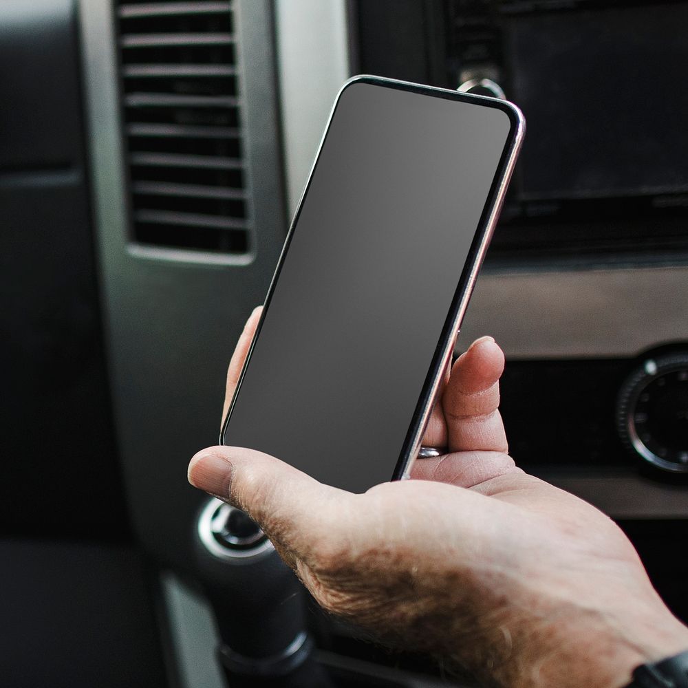 Smartphone black screen mockup psd with car console background