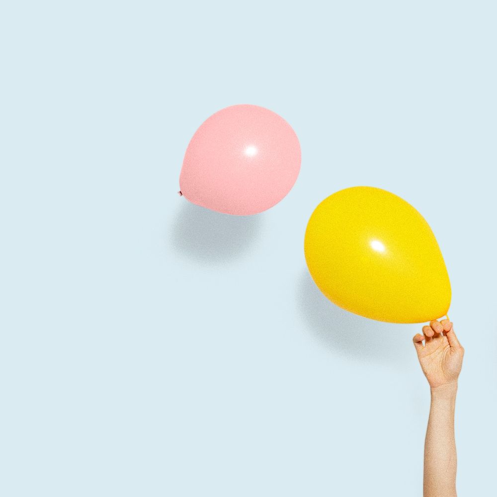 Hand holding a yellow balloon mockup social ads
