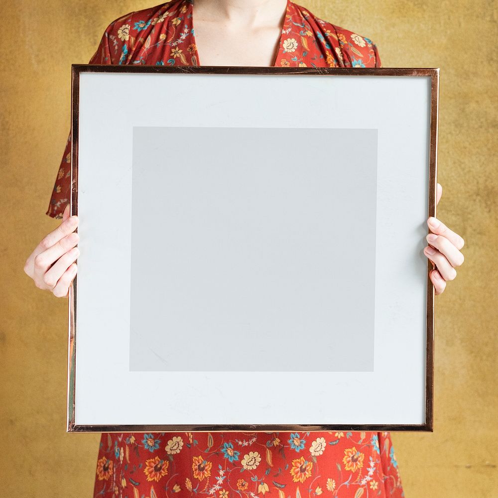 Woman showing a blank photo frame