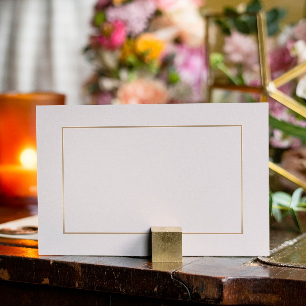 Card by bouquet of flowers on a wooden table