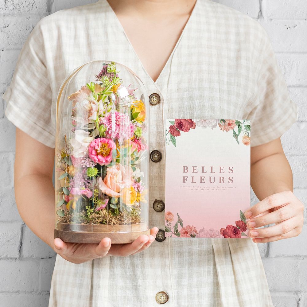 Woman holding a terrarium with floral card mockup