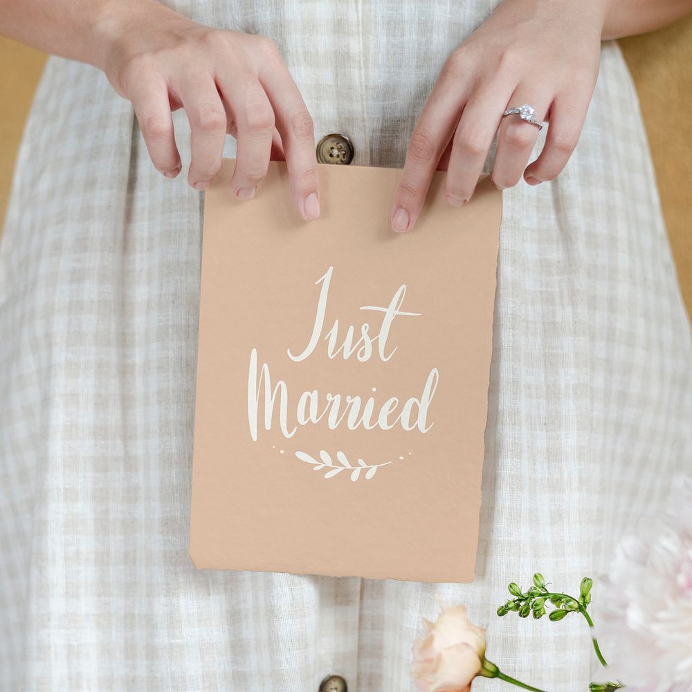 Bride holding a just married card