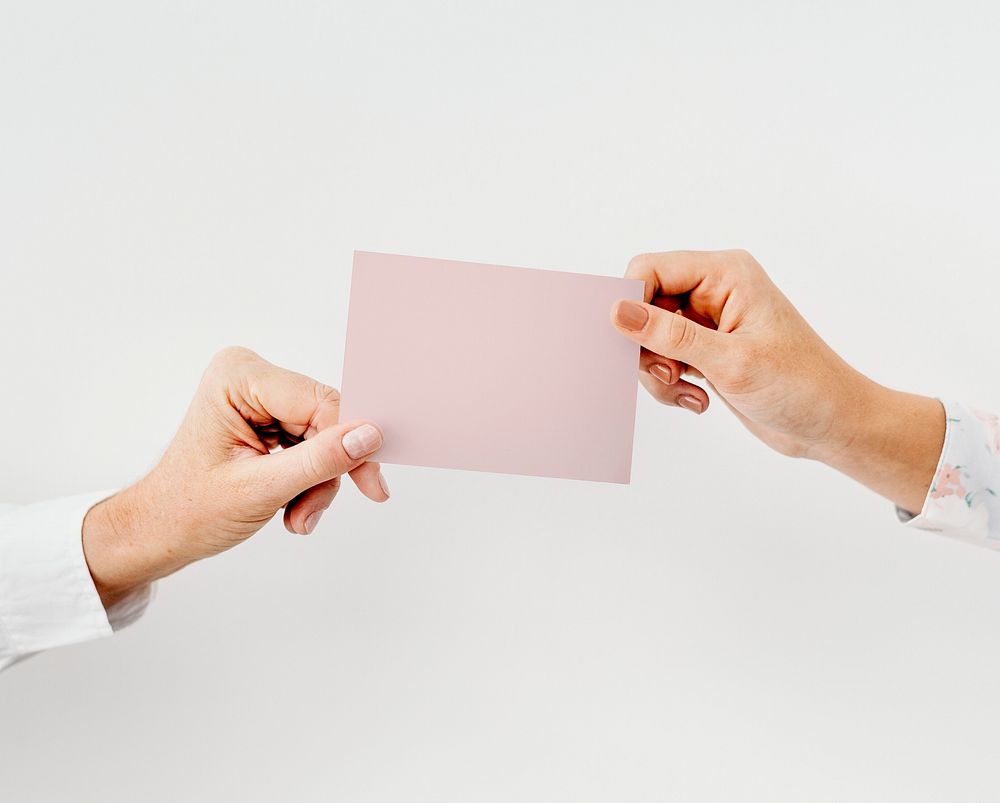 Hands holding a white card
