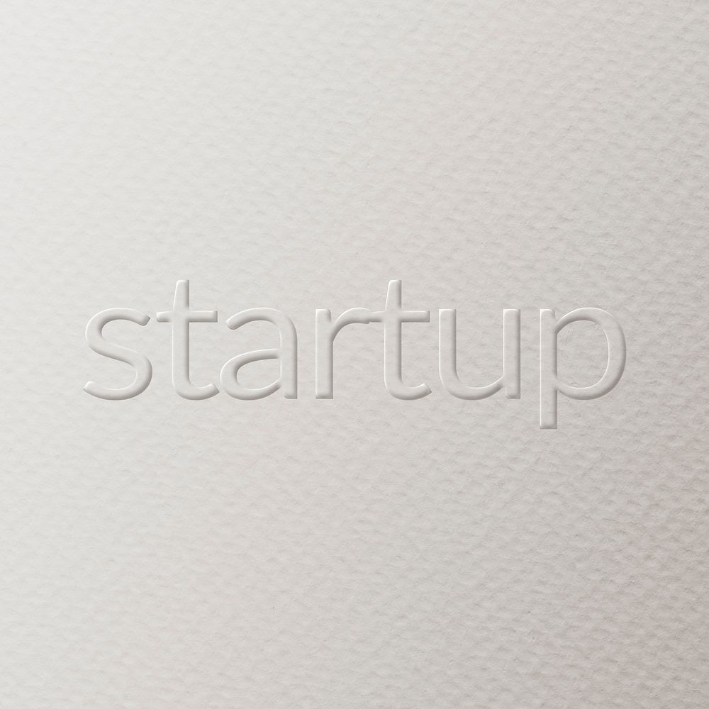 Startup embossed text white paper background