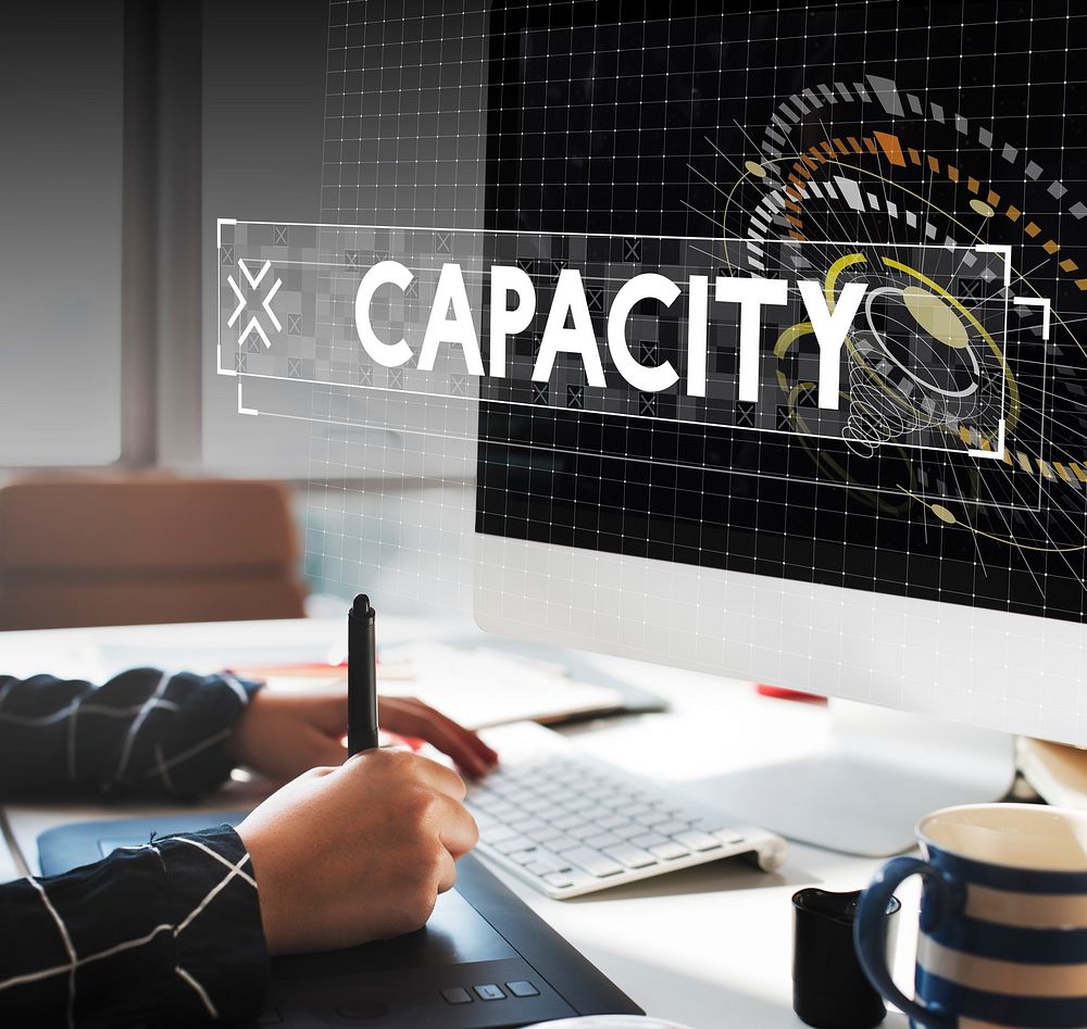 Capacity word graphic design with graphic designer working table