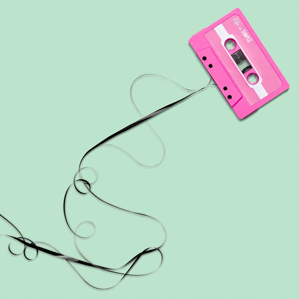 Pulled pink cassette tape on green design