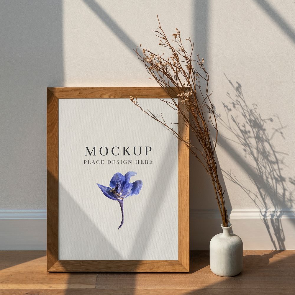 Dried white statice flower in a white vase by a wooden frame  mockup on a wooden floor