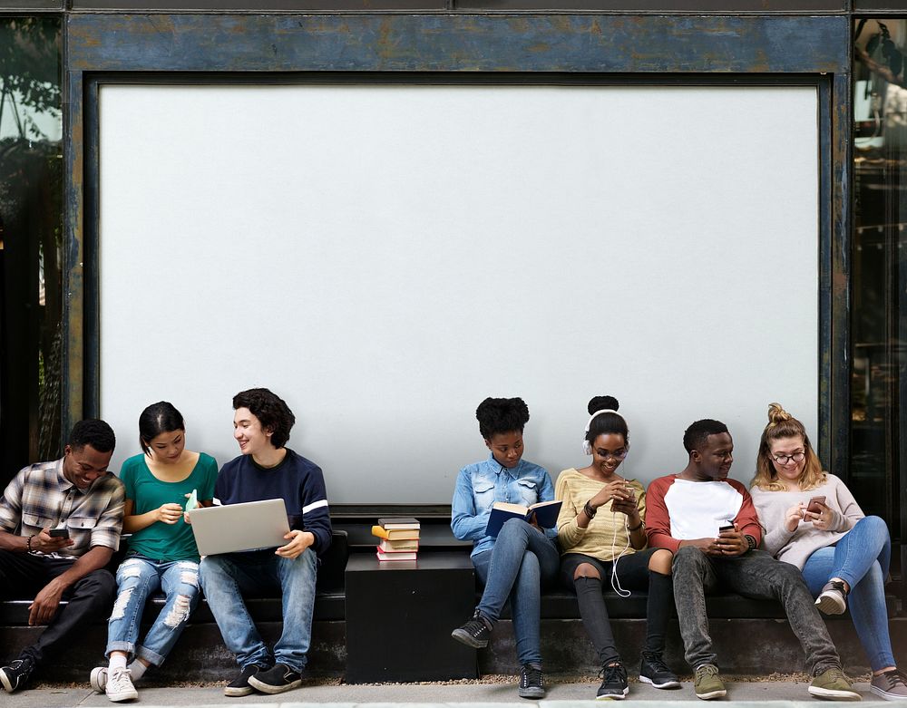 Diverse students sitting in front of a board mockup