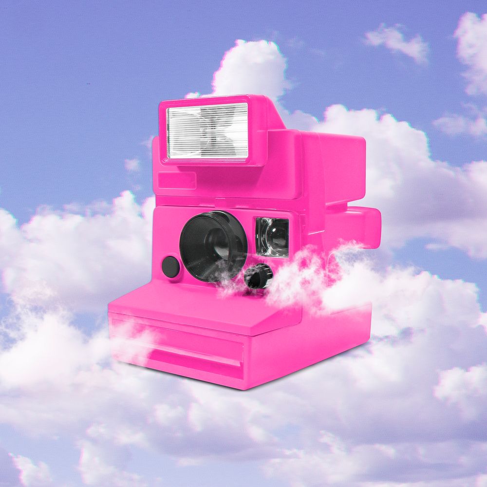 Pink instant film camera on cloudy sky