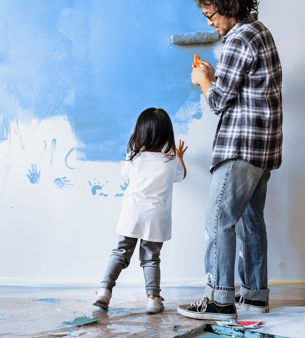 Asian family painting the wall