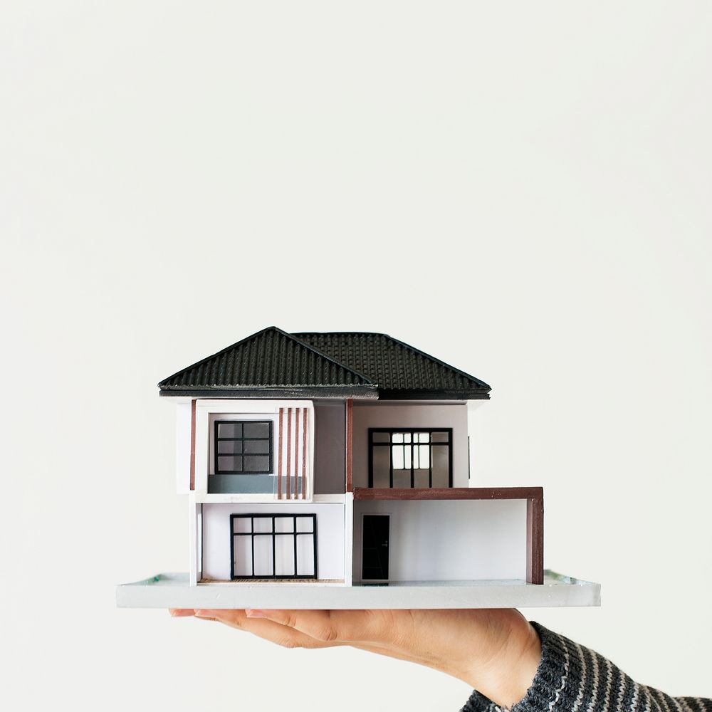 Home insurance, hand holding house model