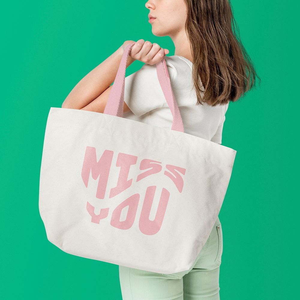 Beige tote bag mockup psd with pink MISS YOU typography