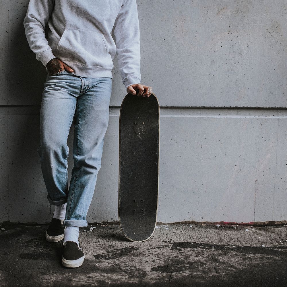 Male skateboarder in sweater, jeans