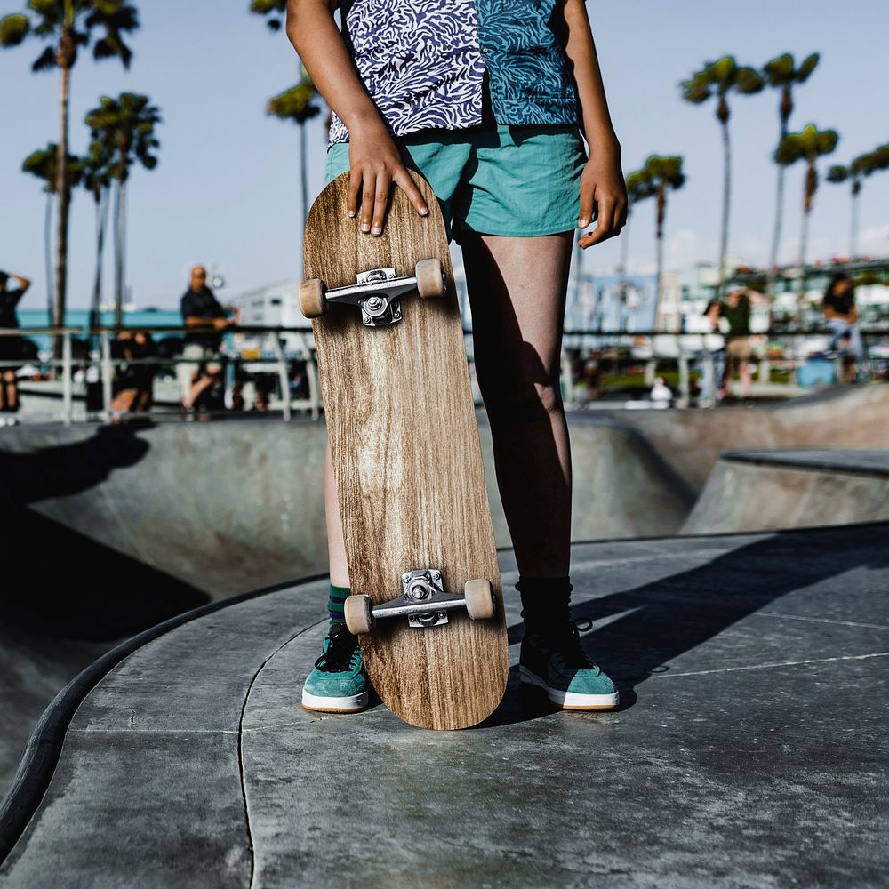 Teen girl with skateboard, skatepark in Venice Beach, LA