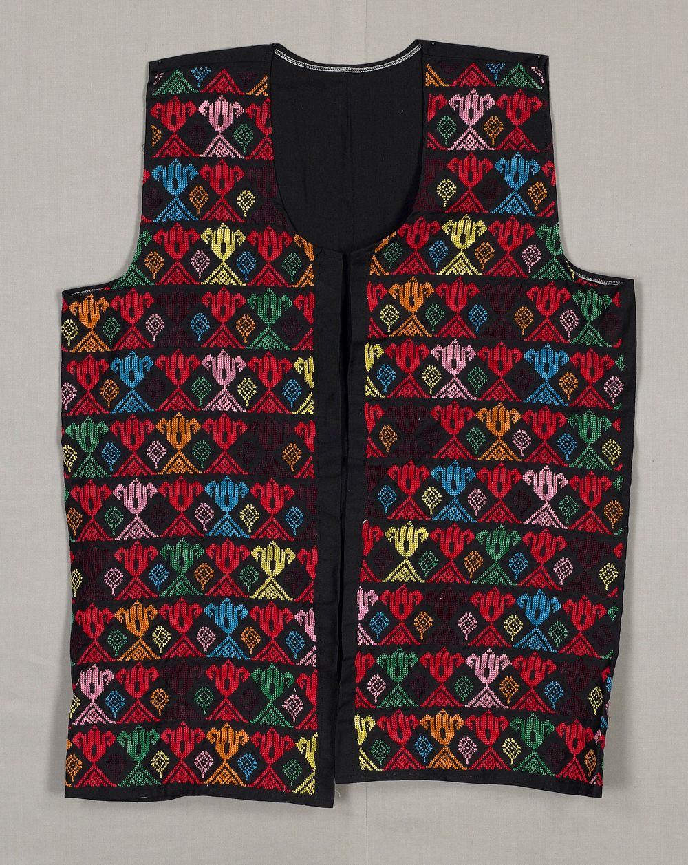 embroidered vest; black with yellow, orange, red, blue, green, wine and pink flower-like geometric cross stitch embroidery…