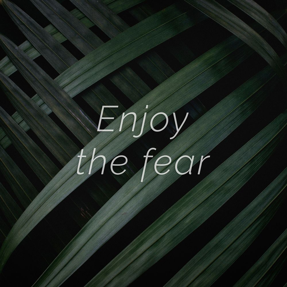 Enjoy the fear quote on a palm leaves background