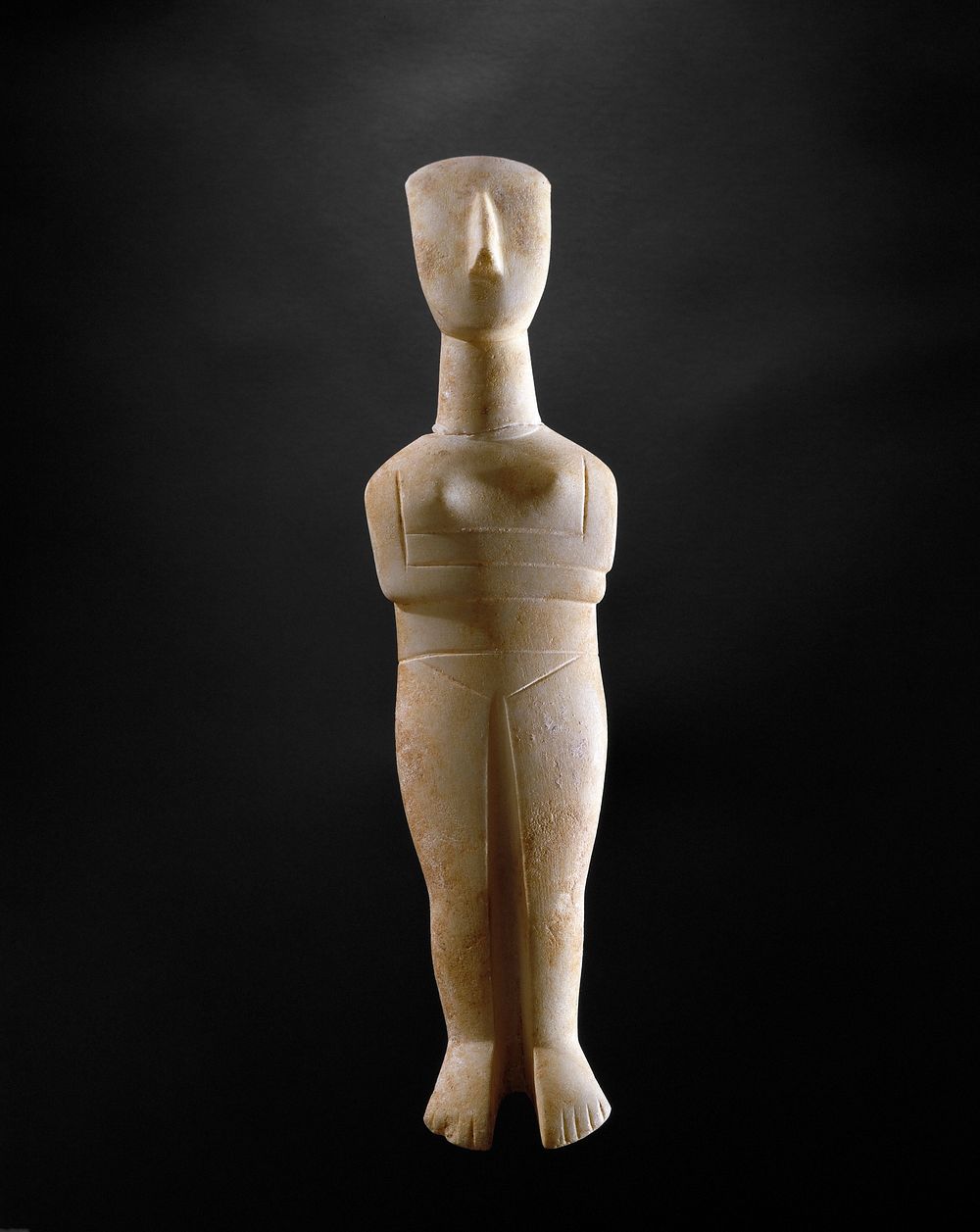 may represent the nature goddess or "Great Mother" of early man.; simple, schematic standing figure with crossed arms.…