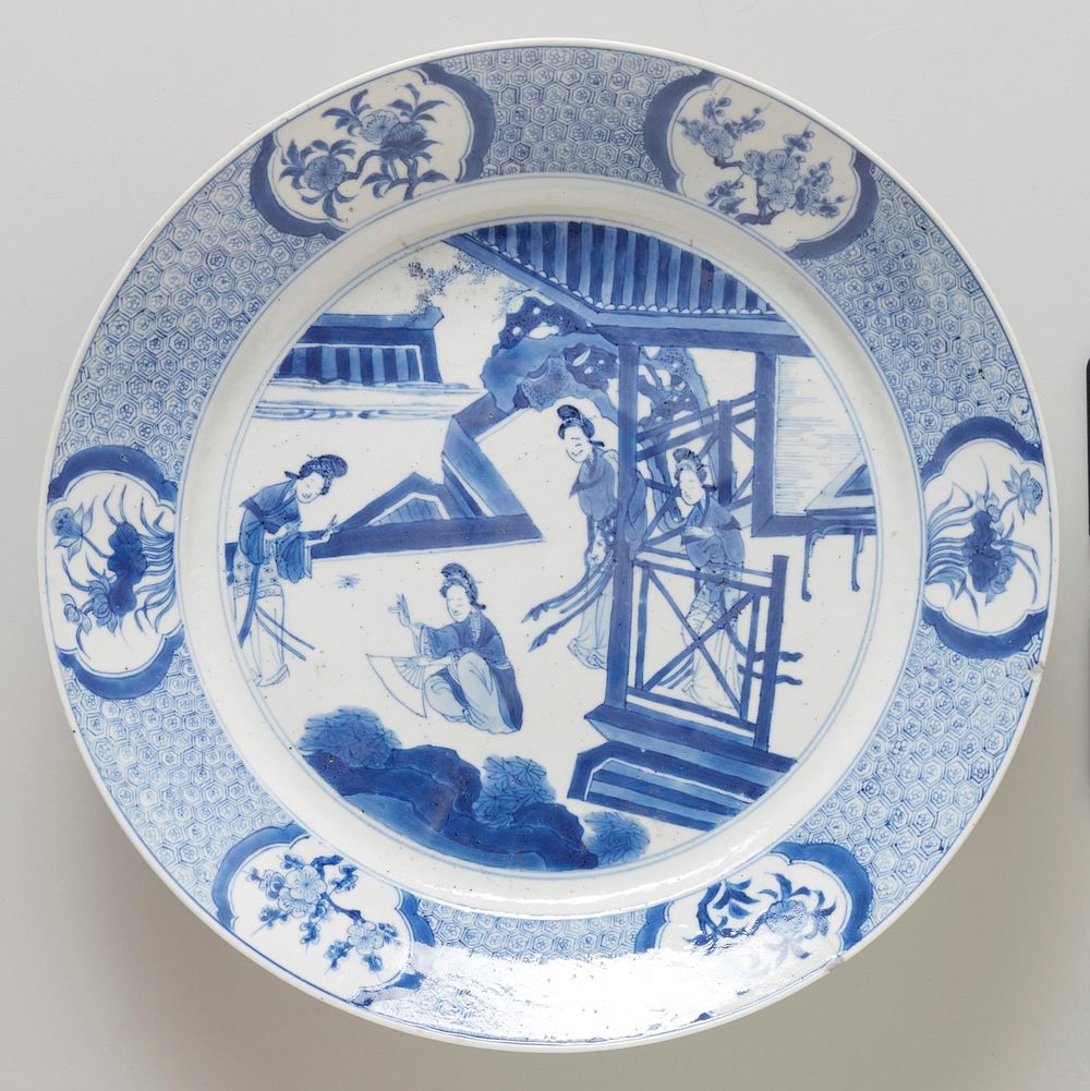 plate, blue on white porcelain; scene of four ladies on the veranda of a pagoda in the center; six floral medallions with…